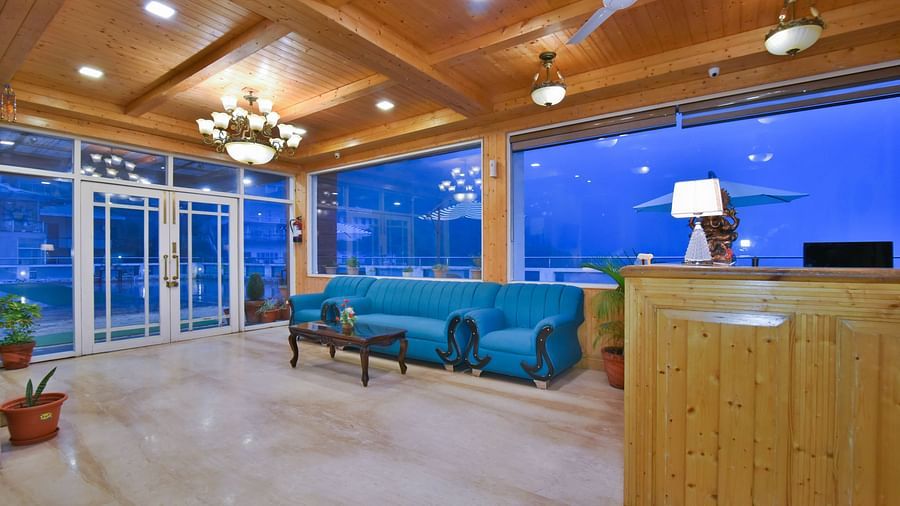 Reception area with a sofa near the reception desk at DLS Highland Resort and Spa, Mussoorie.